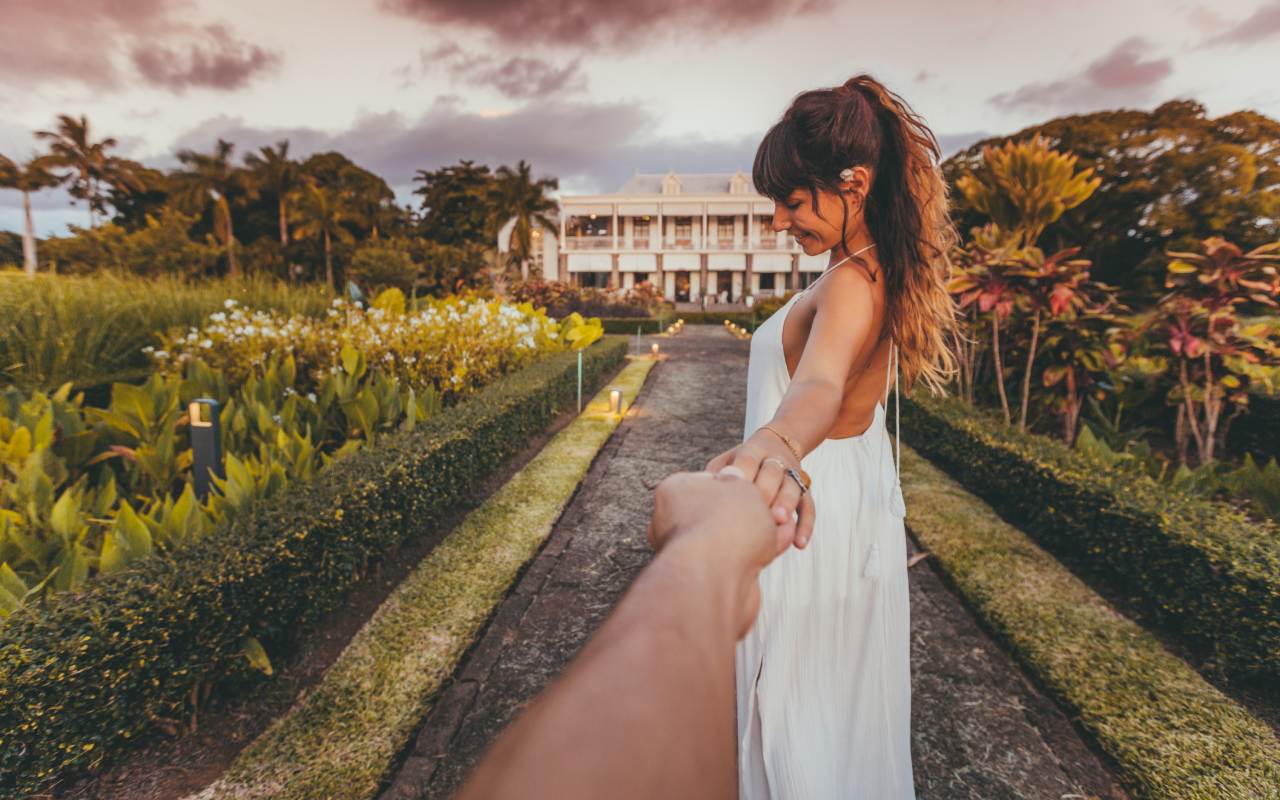 Couple enjoying a romantic garden walk at Le Château de Bel Ombre