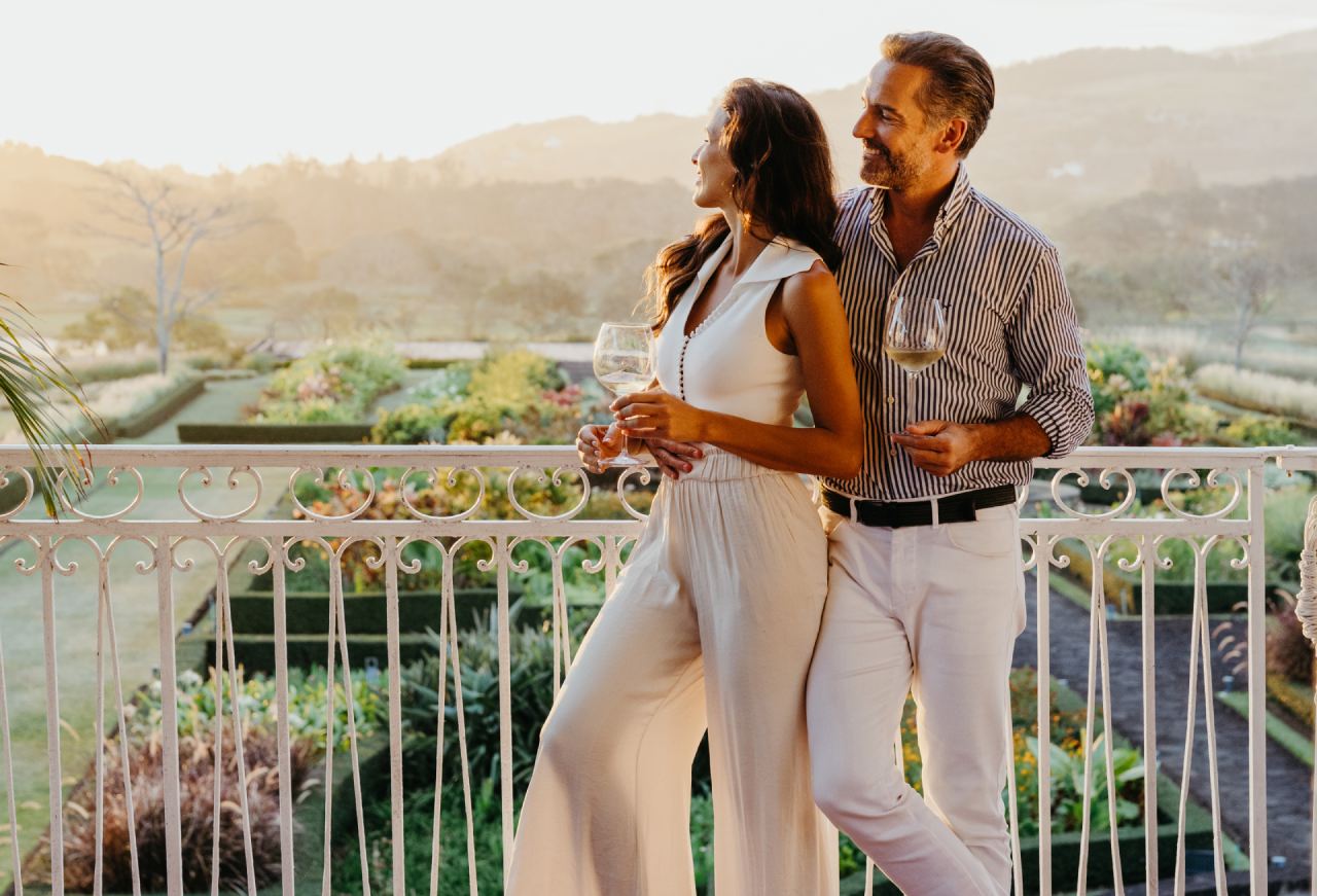 Couple Enjoying a Glass of Cocktail from the Grand Veranda of Le Château de Bel Ombre