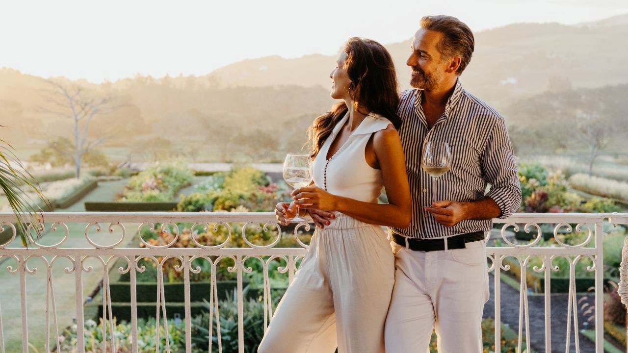 Couple Enjoying a Glass of Cocktail from the Grand Veranda of Le Château de Bel Ombre