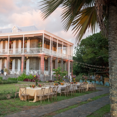 Exterior view of tables set up in the garden of the Château de Bel Ombre