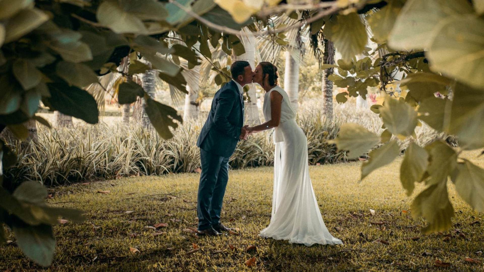 Couple kissing in the French-style garden of Le Château de Bel Ombre, Mauritius